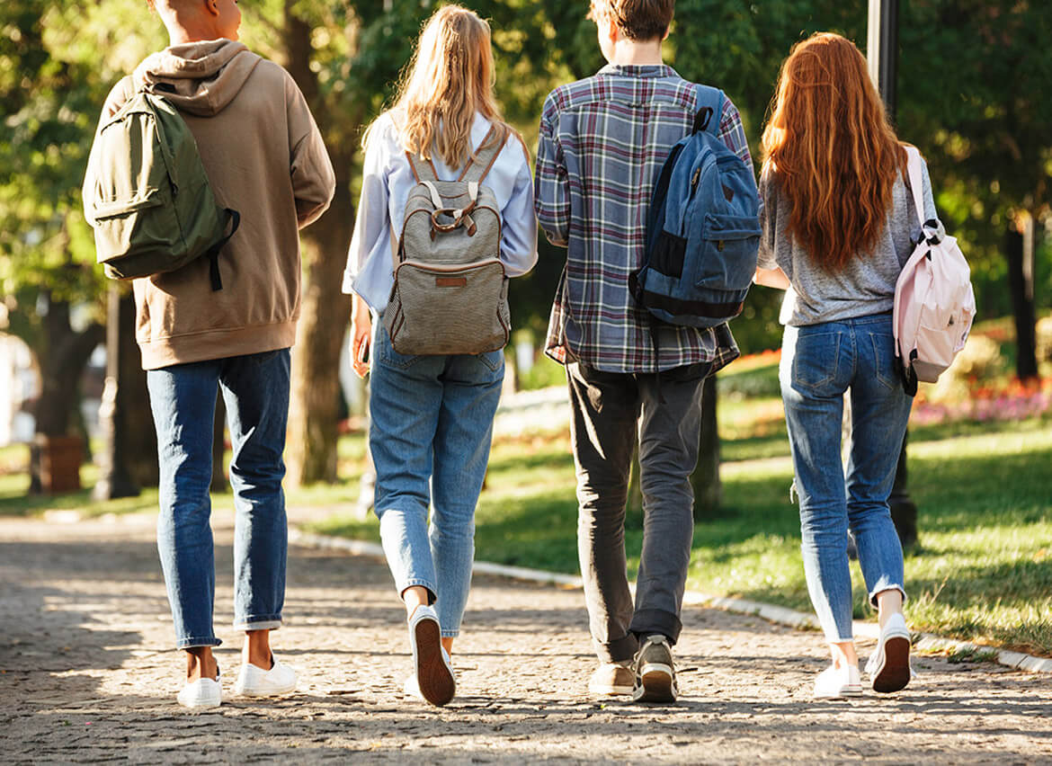 Backside photo of students walking to class.