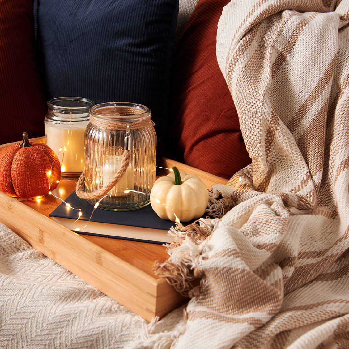 Fall Essentials: Candles and faux pumpkins.