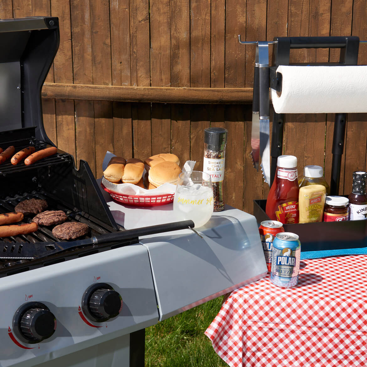 Grilled food with side of condiments and drinks.